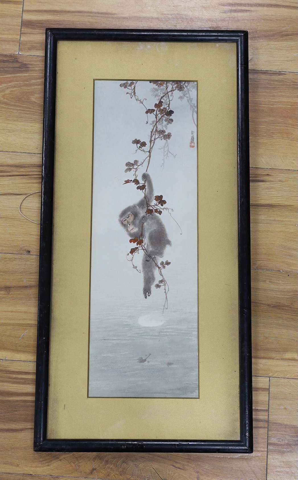 Japanese School, watercolour on paper, monkey hanging on a vine, signed and sealed, 48 x 16cm